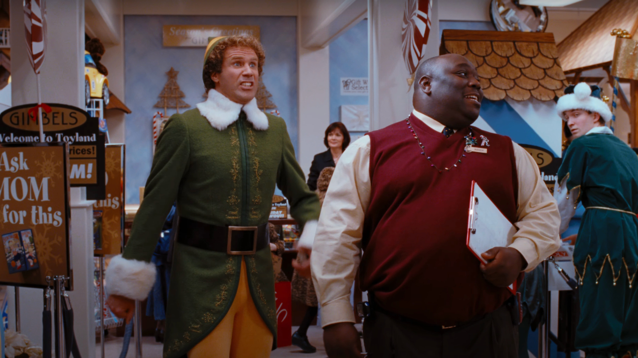 Will Ferrell gets ready to shout behind Faizon Love in Elf.
