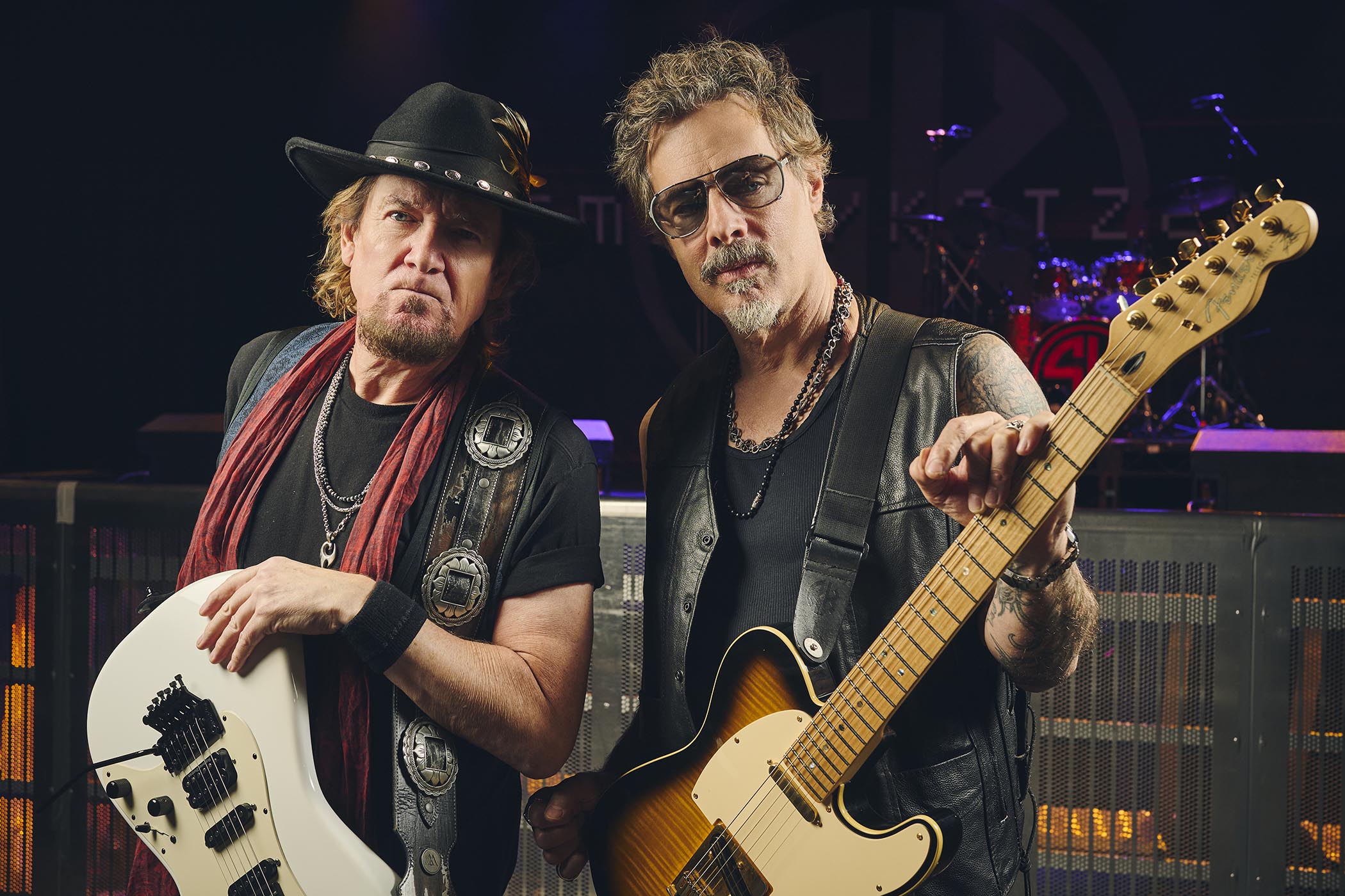 Adrian Smith and Richie Kotzen pictured with their guitars pre-show
