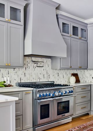 Traditional kitchen with gray cabinets and extractor hood