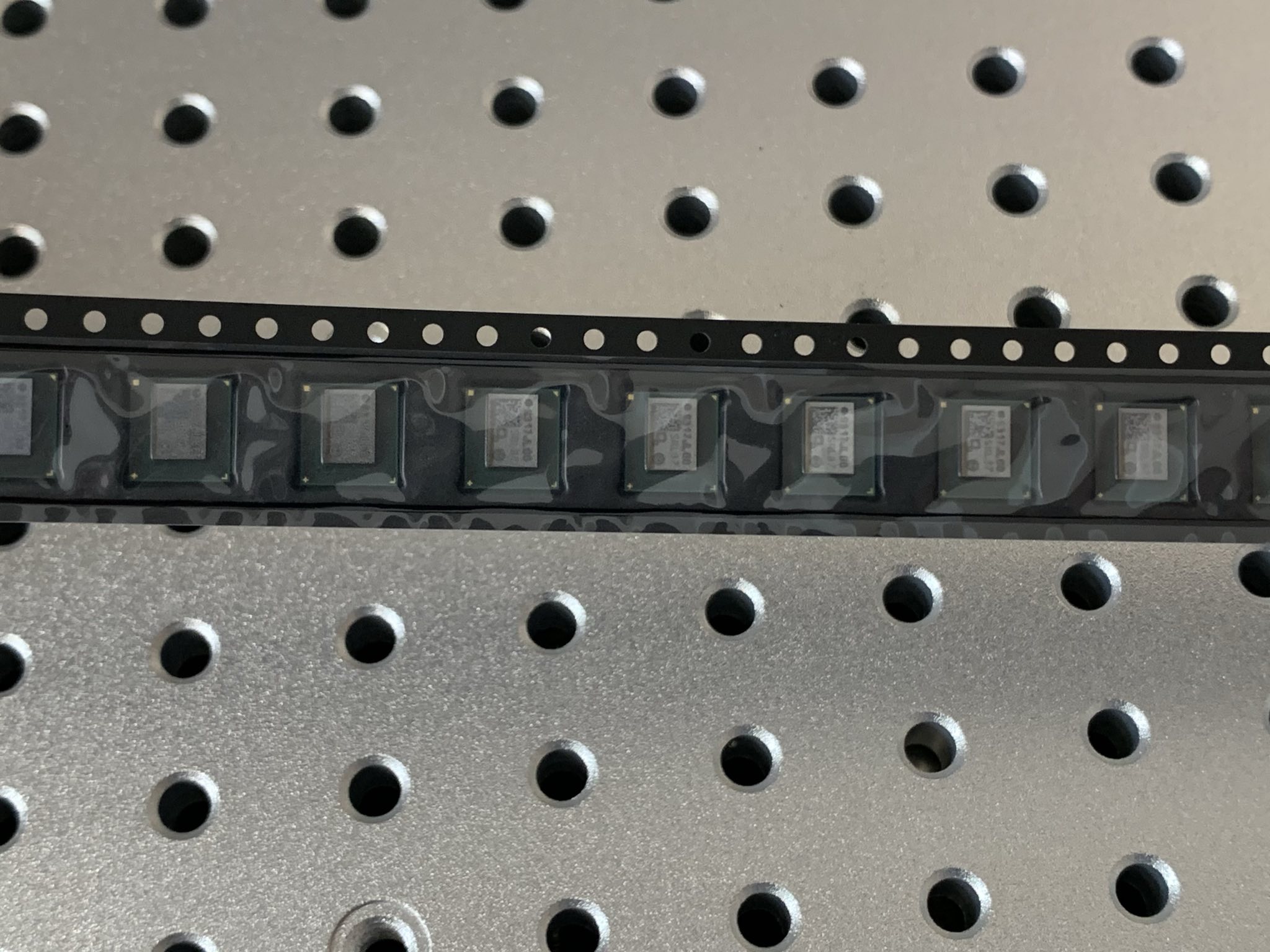 Several BZM2 ASICs packaged on a reel.