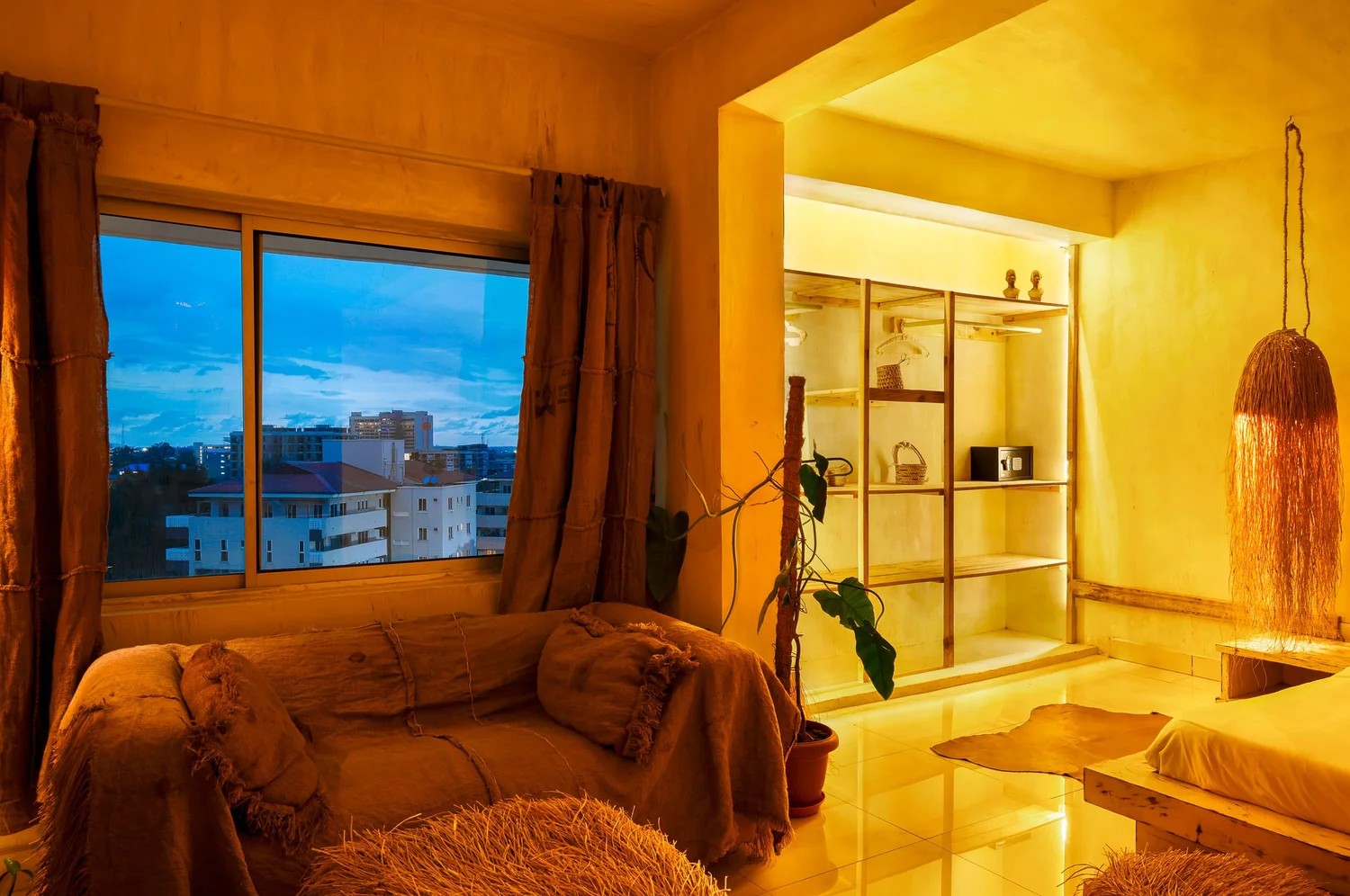 A texturally decorated hotel houses plenty of trailing plants, wooden furniture, and colorful and tactile art installations.