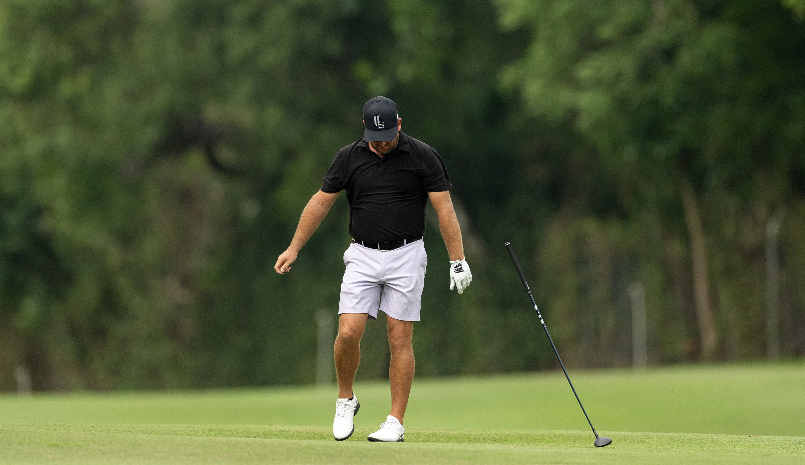 Graeme McDowell throws a club on the ground
