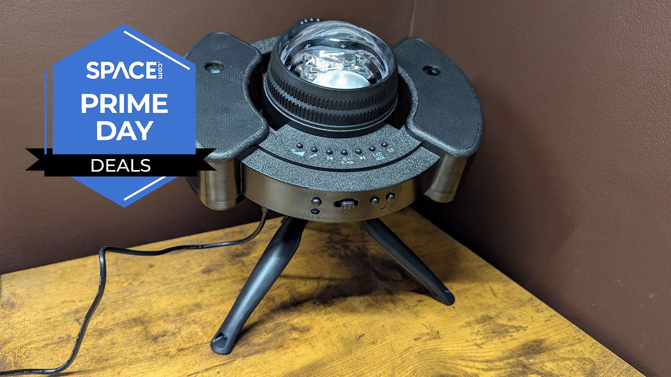 A black round object with a bulb coming out of the top is standing on a stand on a brown wooden surface with the Space.com logo in the top left corner.