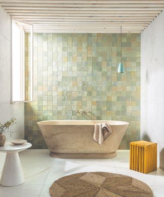 Green and yellow tile backsplash, stone bath, yellow stool