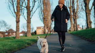 How to lower your blood pressure quickly: woman walking dog
