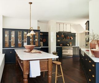 dark blue kitchen with wooden island