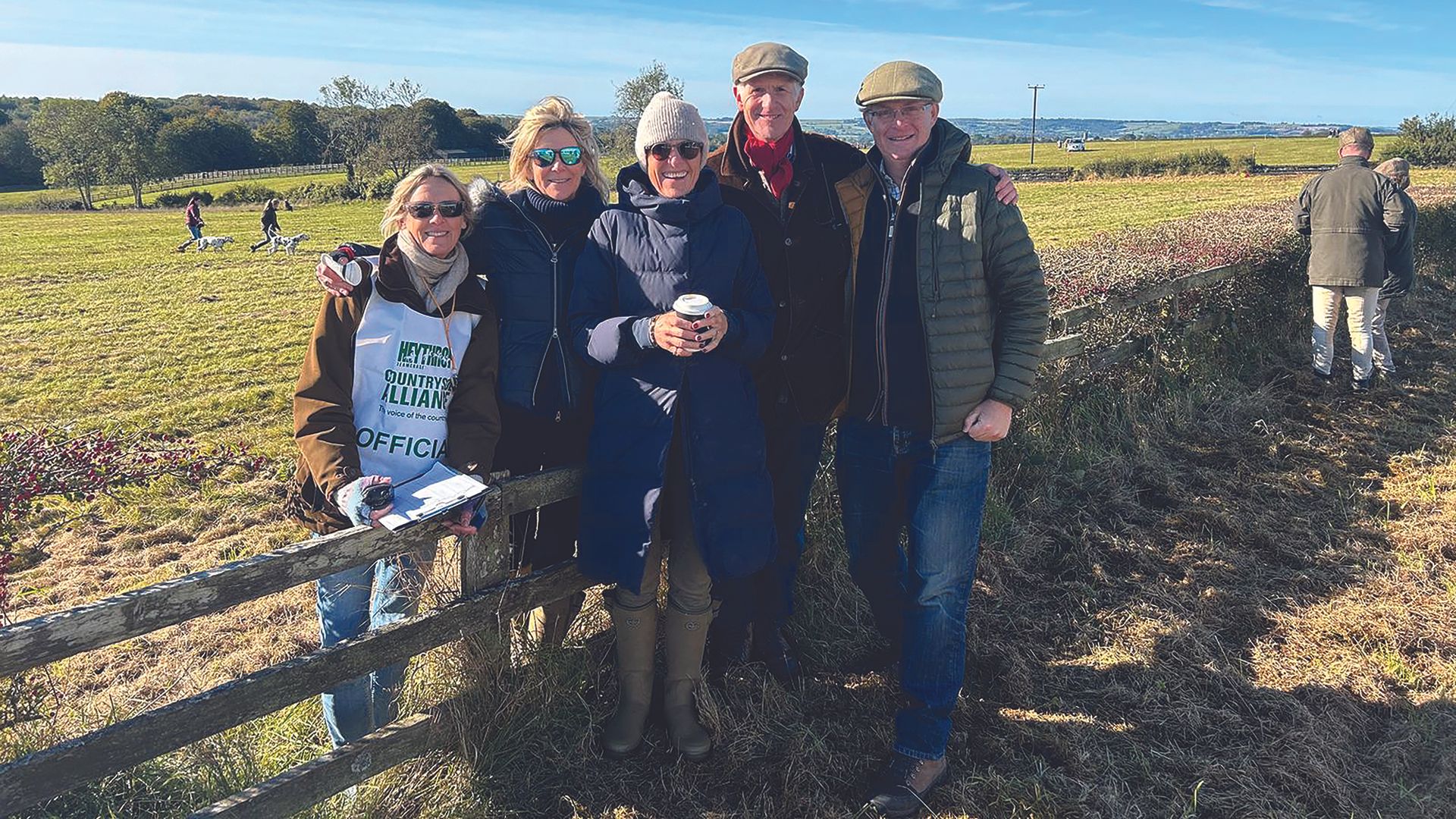 Jonathan Hull pictured with friends on foot beside a fence at a team chase