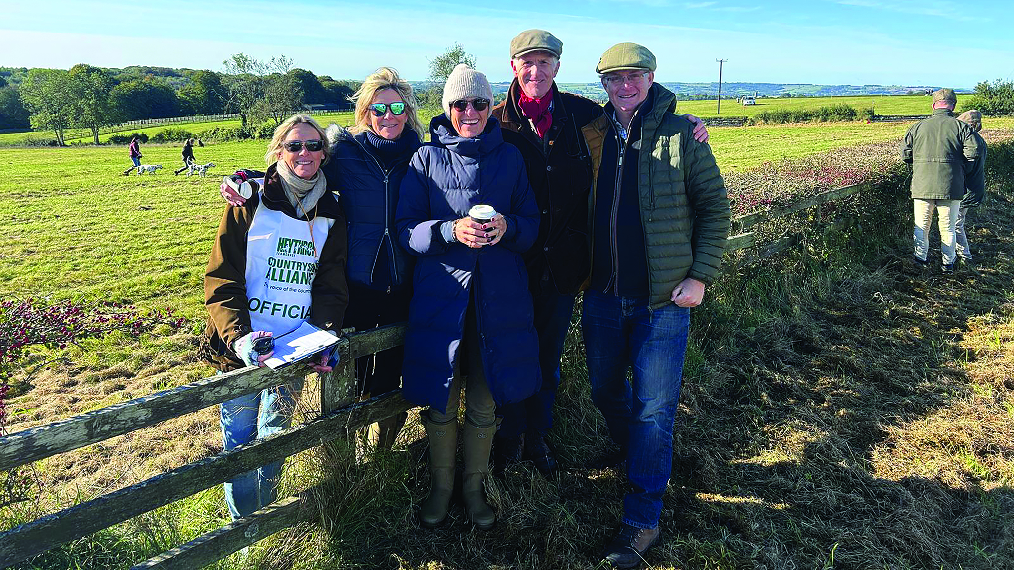 Jonathan Hull pictured with friends on foot beside a fence at a team chase