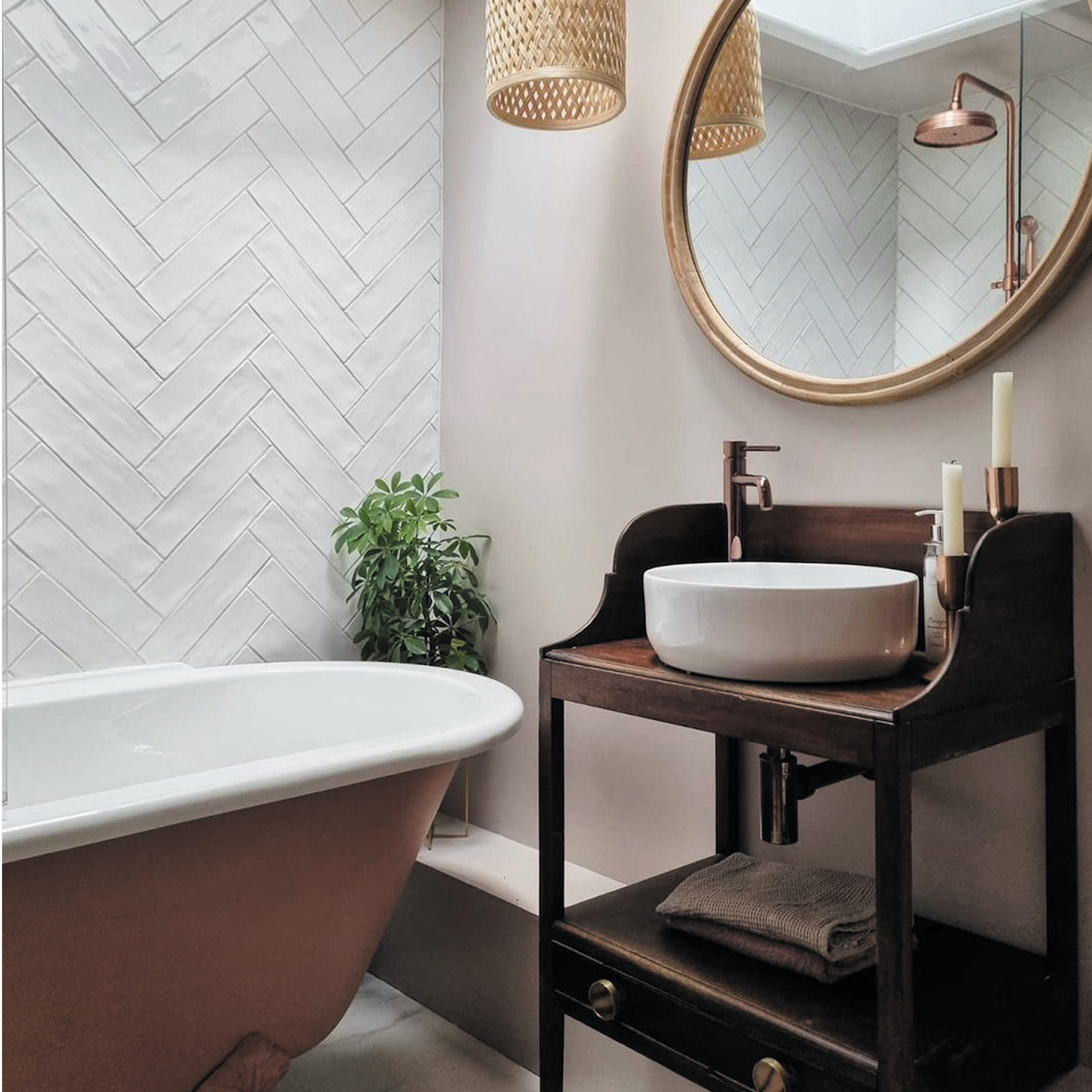 pink bathroom with white tiles and wooden vanity