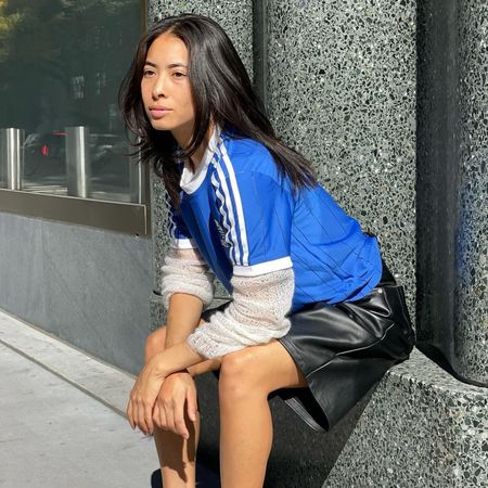 Influencer wears Adidas Taekwondo trainers with a blue jersey.