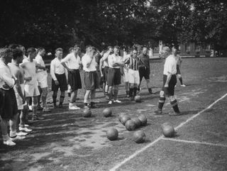 Aston Villa manager Jimmy Hogan gives instructions to a group of players at the Duke of York's Headquarters in Chelsea in August 1936.