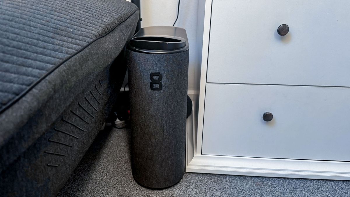 Eight Sleep Pod 4 black control hub between bed and white chest of drawers
