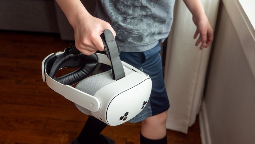 A child holding a Meta Quest 3S with a Yoges head strap