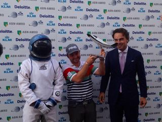 Golfer Andy Sullivan holds a scale model of XCOR Aerospace's Lynx rocket plane after winning a trip to space when he sunk a hole in one at the KLM Open tournament in the Netherlands on Sept. 14, 2014.