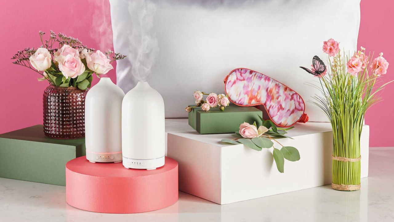 Aldi electric diffusers on display with flowers and pillows