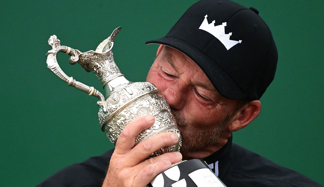 Alex Cekja kisses the trophy