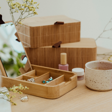 Wooden jewellery box and coffee mug on a wooden table