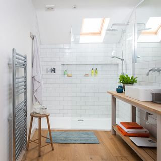 shower room with wooden flooring and white tiles
