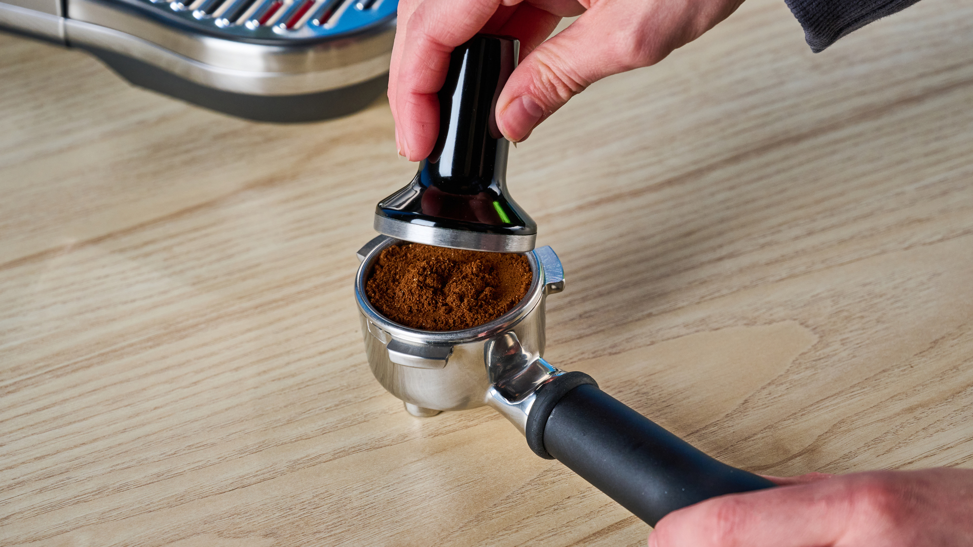 the breville bambino plus / sage bambino plus in stainless steel silver photographed against a blue background shown with its accessories including milk jug, tamper, portafilter, and shown in use extracting espresso