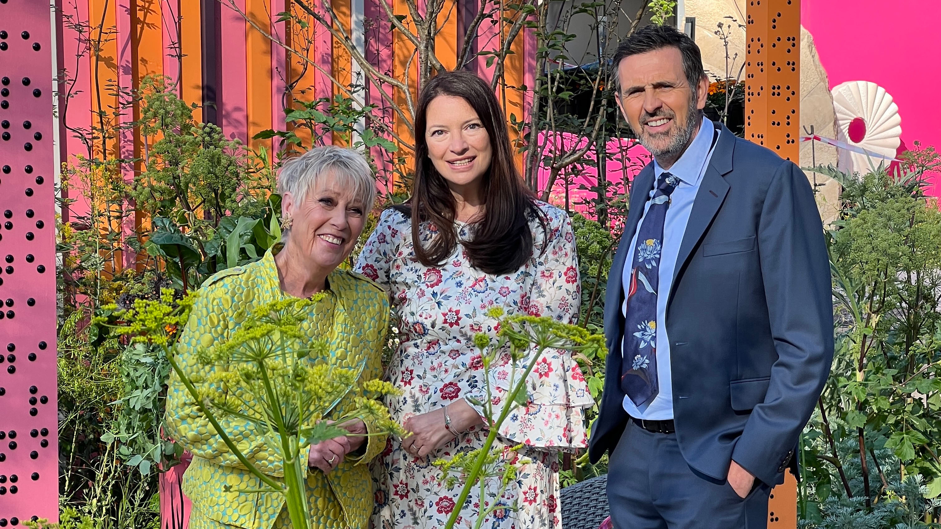 Carol Klein, Rachel De Thame and Adam Frost standing in a garden for The RHS Chelsea Flower Show 2025