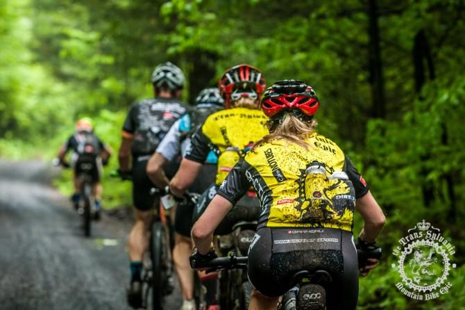 Lisa Le Poole and Kristin Walters ride in the peloton on the gravel roads of Stage 4.