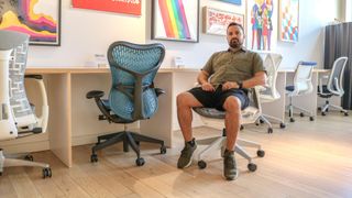 A person sitting in an office chair in a Herman Miller store