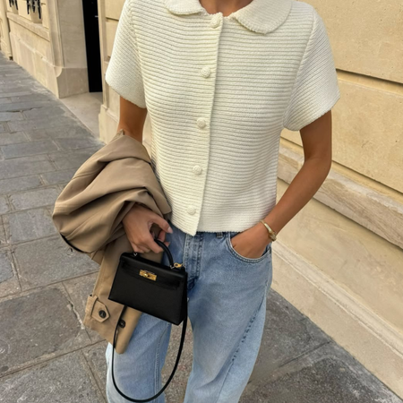 woman wearing white short-sleeve collared button-down sweater and jeans