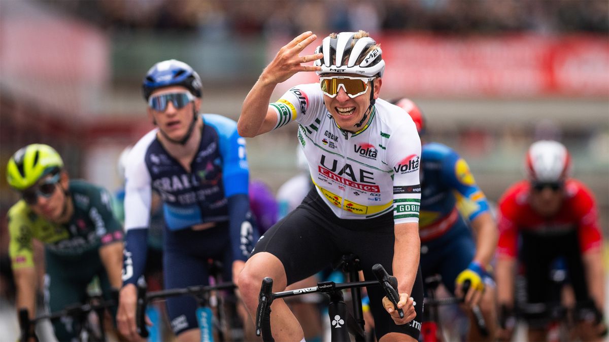 Tadej Pogačar celebrates crossing the line first in the 2024 Volta Ciclista a Catalunya 