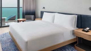 Hampton by Hilton Marjan Island King Guest Room featuring the Hampton Bed dressed in white sheets