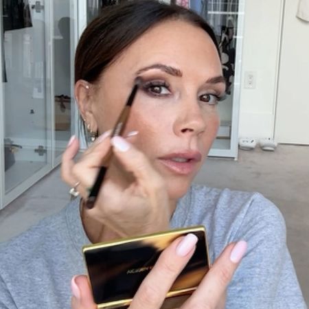 Victoria Beckham applying eyeshadow