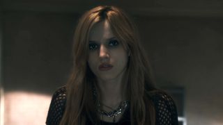 Bella Thorne looking out the window in Amityville: The Awakening