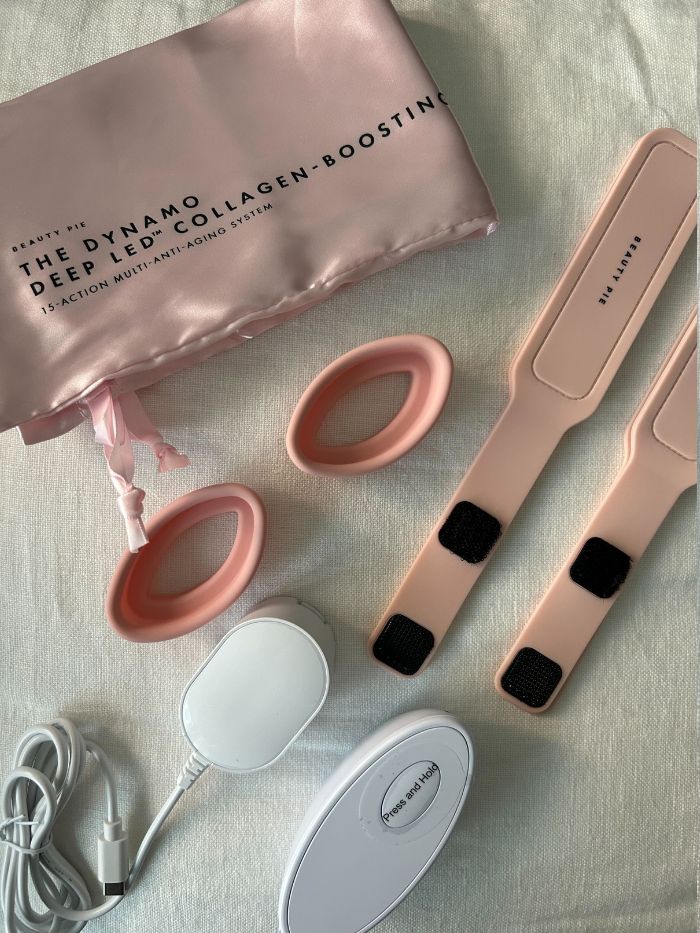 The new Beauty Pie LED mask and its attachments on a white linen background