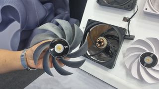 The fan blades removed from a Thermaltake Toughfan EX14 Pro, held in the hand at Computex 2024