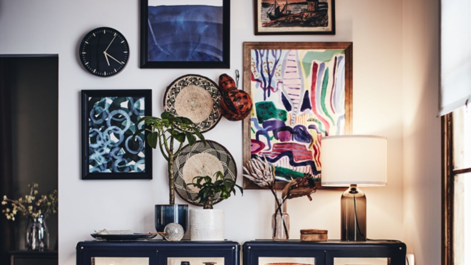 bold wall art showing cluttercore bedroom trend for 2022