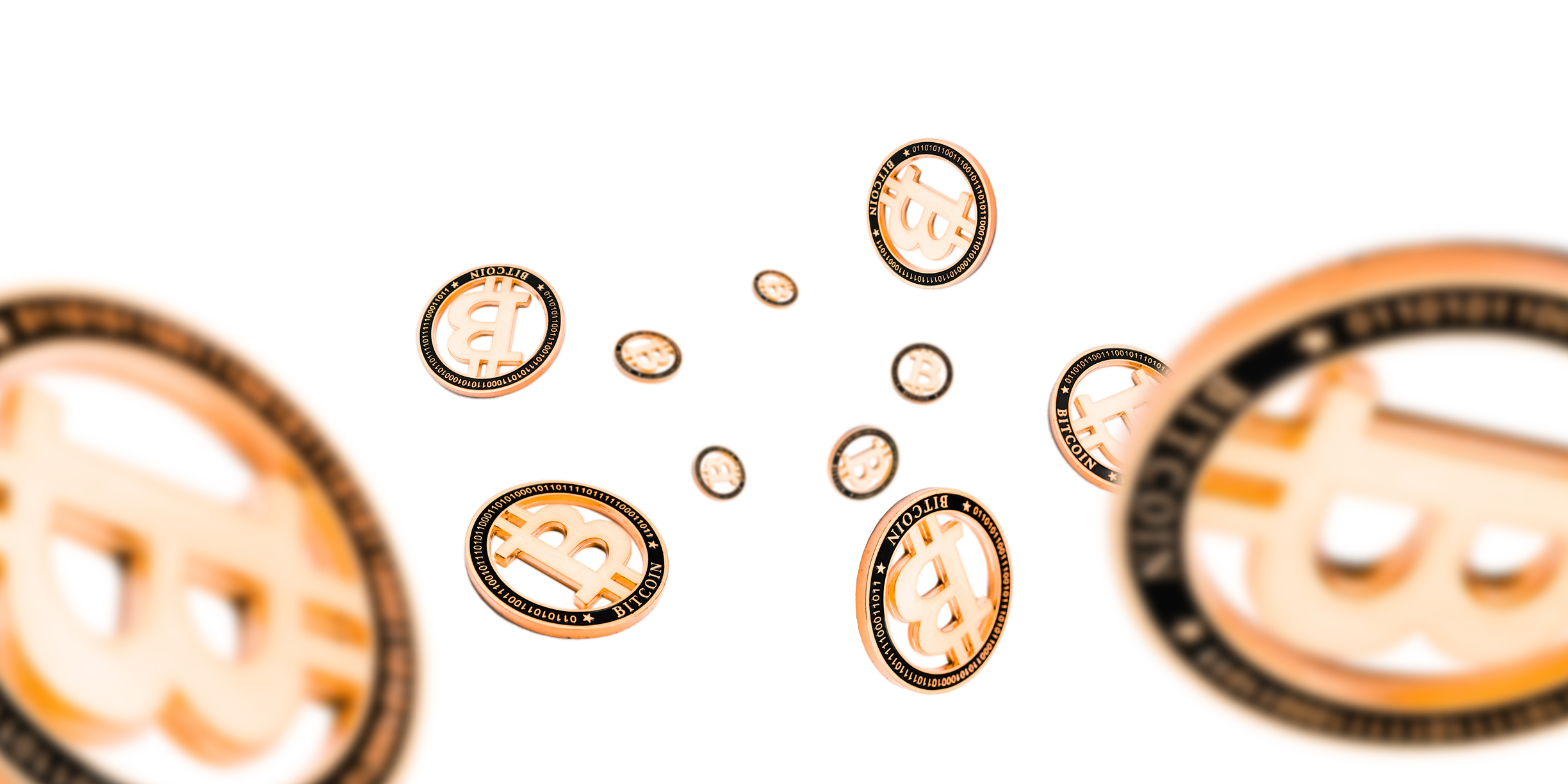 Cryptocurrency coins falling against a white background