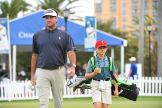 Bubba and Caleb Watson walk to the first tee at the PNC Championship