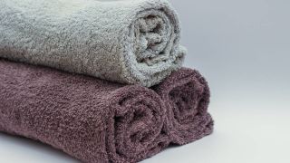 Three rolled up towels stacked on top of each other