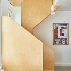 Compact wooden staircase leading to loft area