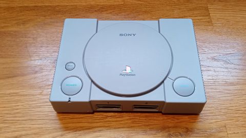 A photo of the PlayStation Classic on a wooden table