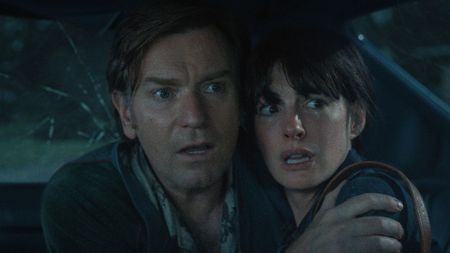 Ewan McGregor and Anne Hathaway cowering in fear in The End of Oak Street