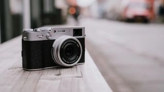 Fujifilm X100V review: camera on stone wall in city street