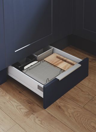 Kitchen drawer in toe kick in blue cabinet