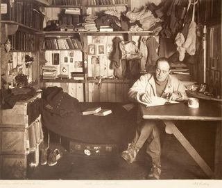Robert Falcon Scott in the expedition's well-stocked hut.