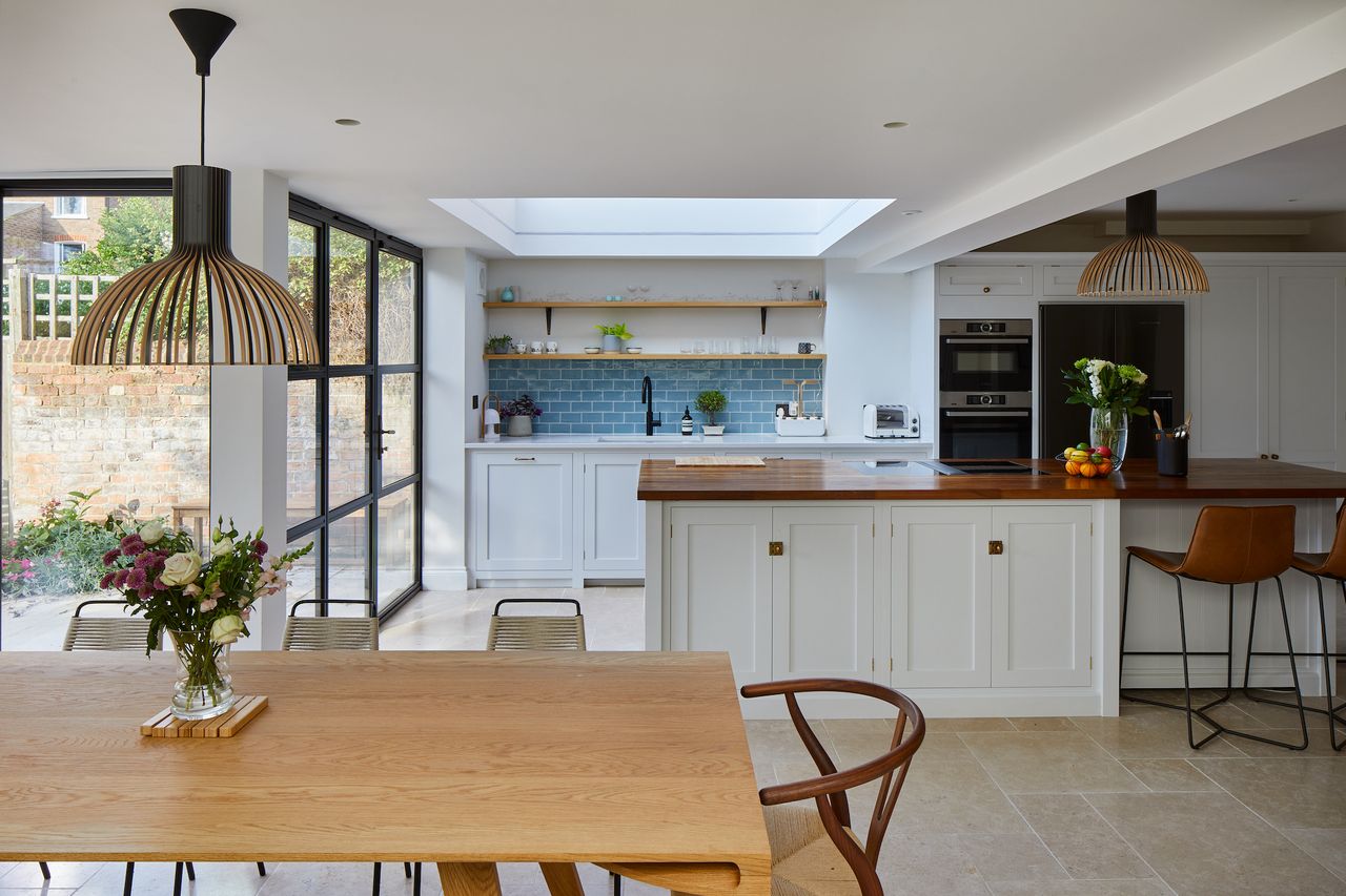 blue and white open plan kitchen diner with island