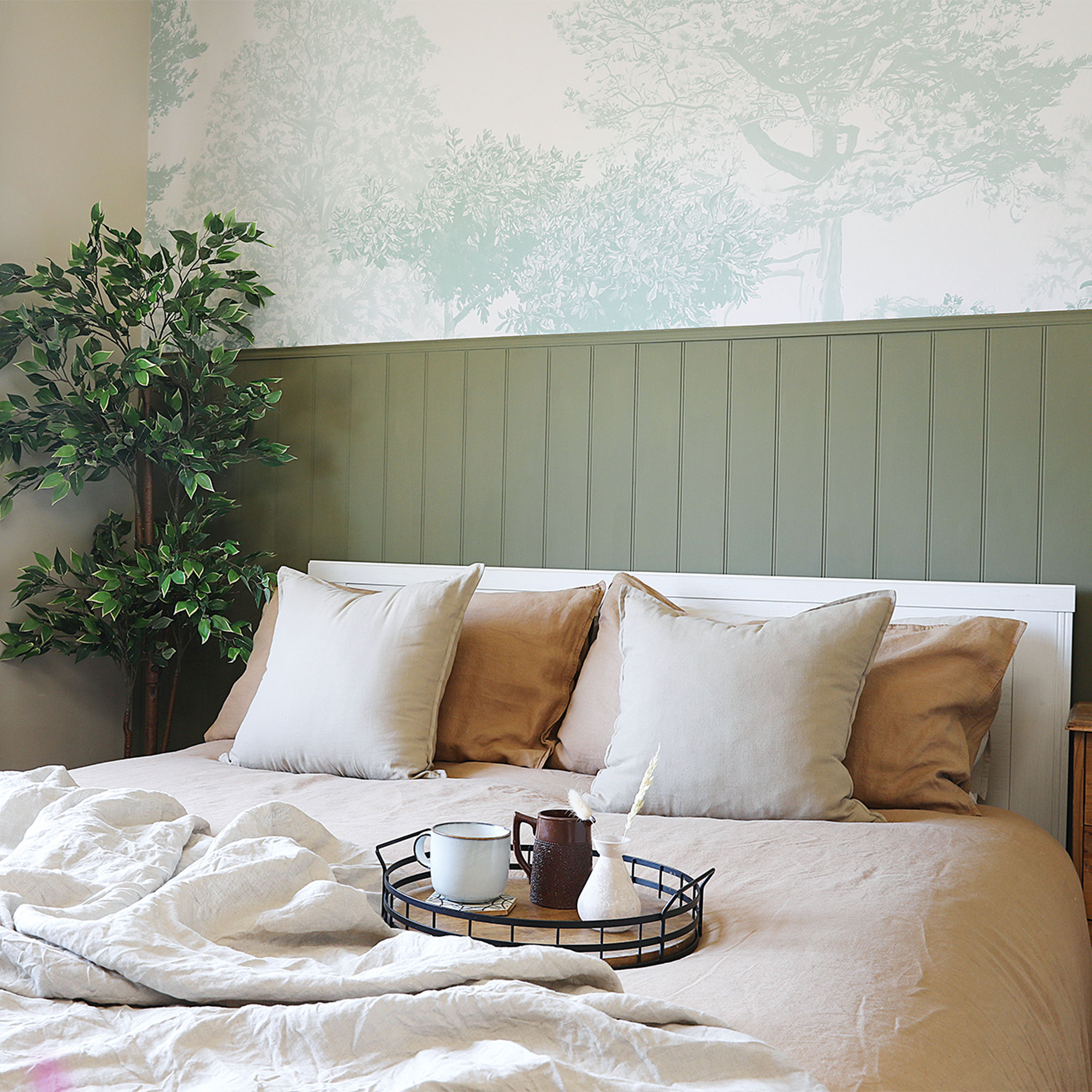green bedroom with panelling and wallpaper