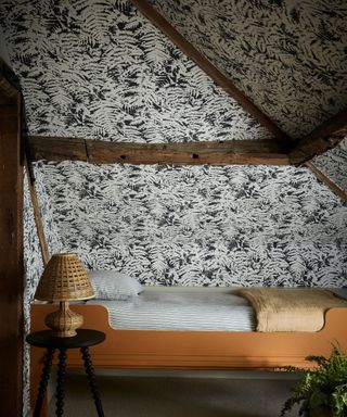 Black and white fern wallpaper, orange bedframe