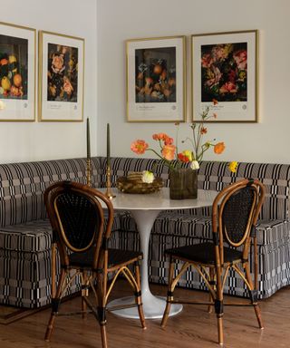 patterned upholstered dining nook with floral wall art
