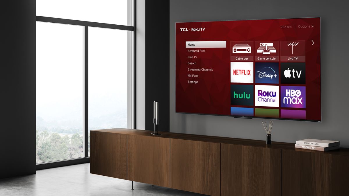 The 2022 TCL R655 hanging on a wall in a living room.