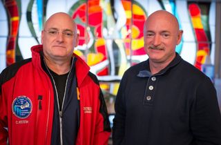 Scott Kelly, left, and his identical twin brother Mark pose for a photo at the Cosmonaut Hotel in Baikonur, Kazakhstan on on March 26, 2015, one day before Scott was scheduled to launch on a one-year mission to the International Space Station.