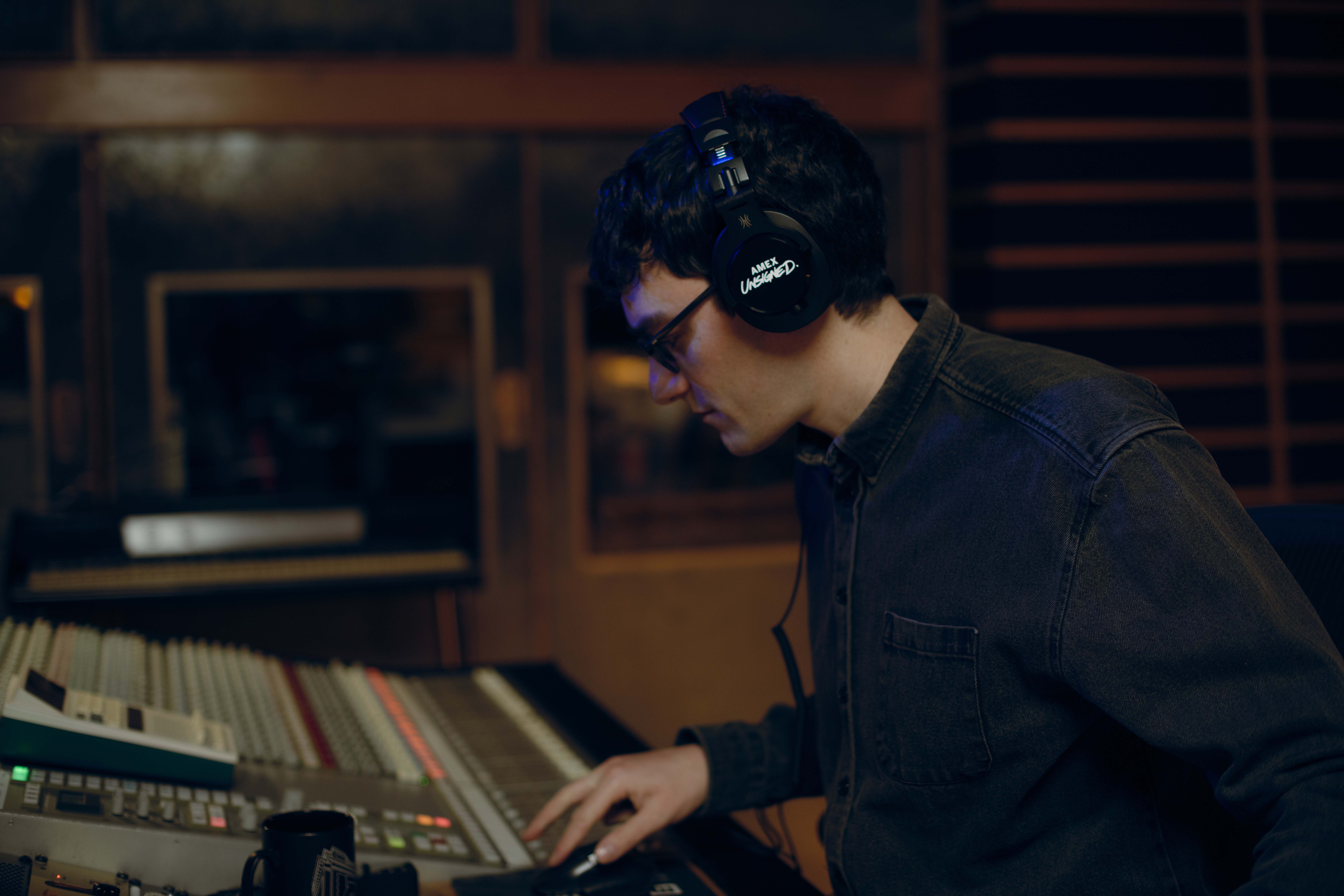 danny l harle in the studio with headphones on